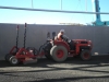 tractor and drag scoop working close to wall
