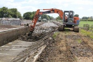 cleaning weeping wall with digger