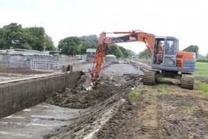 cleaning weeping wall with digger